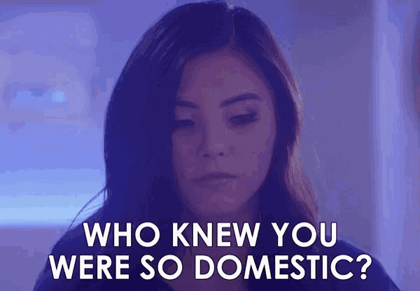 a woman is looking down and asking who knew you were so domestic .