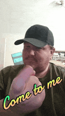 a man wearing a hat and a t-shirt says come to me