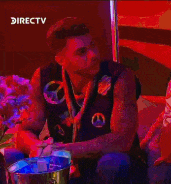 a man sitting on a couch with a peace sign around his neck