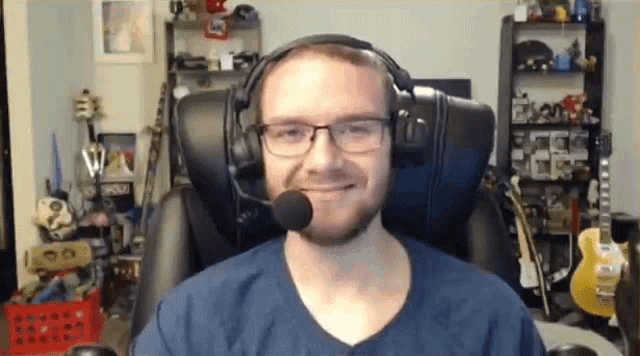 a man wearing glasses and headphones with a microphone on his head