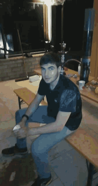 a person is kneeling down on a tiled floor with a dirty shoe on the floor