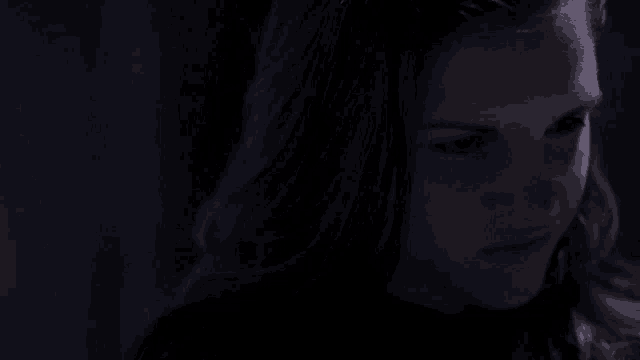 a close up of a woman 's face in the dark .