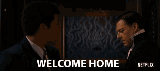 two men standing next to each other with the words welcome home written on the bottom