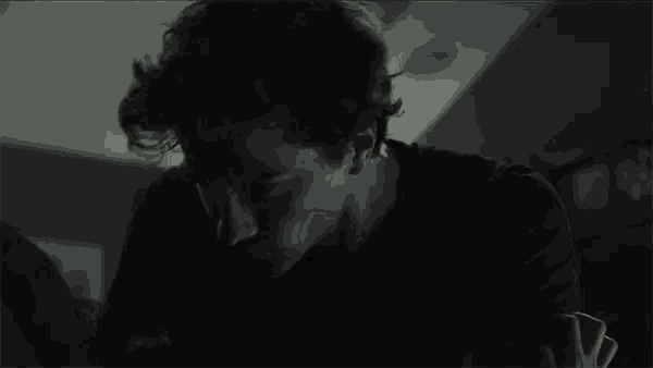 a close up of a man 's face in a dark room .