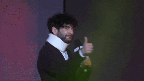 a man in a suit holds a microphone that says a&w on it
