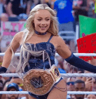 a woman in a wrestling ring with a belt that says nb