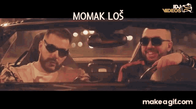 two men in a car with the words momak los on the bottom right