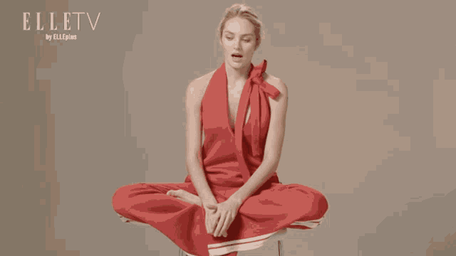 a woman in a red dress with elletv on the bottom