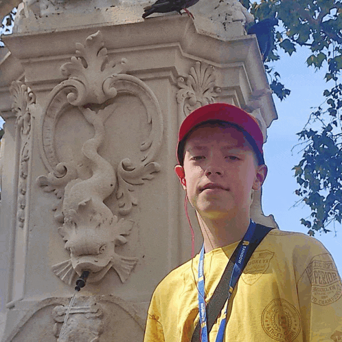 a young boy wearing a yellow shirt with a lanyard around his neck that says microsoft