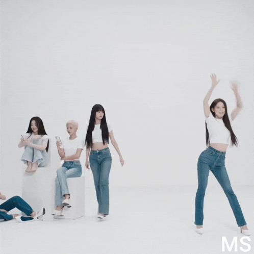 a group of women are standing in front of a white wall with the letters ms on the bottom