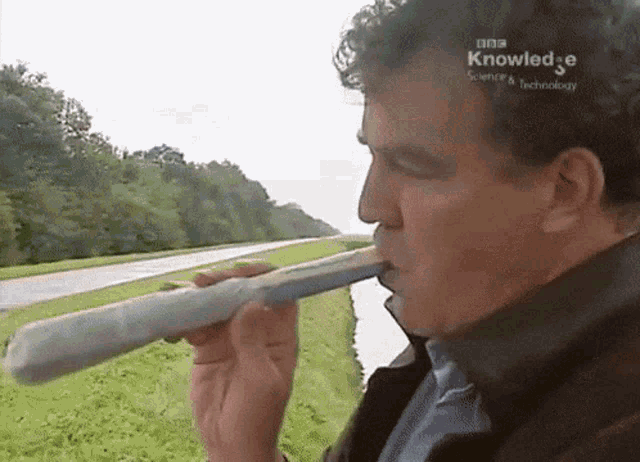 a man blowing into a tube with bbc knowledge science & technology written on the screen