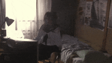 a wanted poster hangs on a wall next to a bed