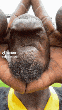 a man with a beard is making a face with his hands and a tiktok watermark