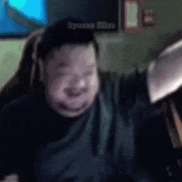 a man is sitting in a chair with his arms outstretched and the name ryanne eliza on the bottom right