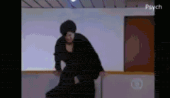 a woman in a black dress is dancing in a room with the words psych on the bottom