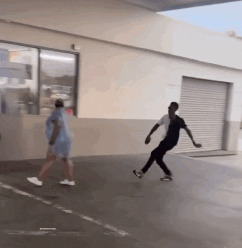 a man and a woman are walking down a street