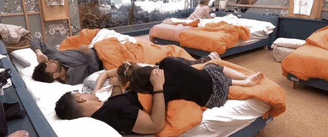 a group of people laying on beds in a room with a sign that says ' ikea '