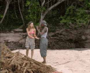 a man and a woman are standing on a beach