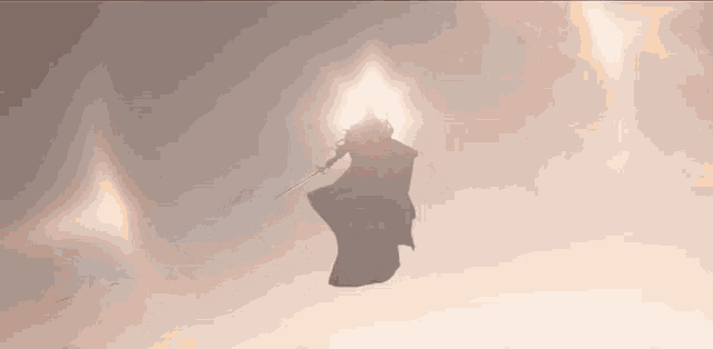 a silhouette of a person flying through the air with a sword and cape .