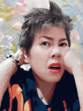 a woman making a funny face with her hand on her face