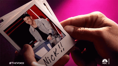 Looking At Photos Nick Jonas GIF - Looking At Photos Nick Jonas Blake Shelton GIFs