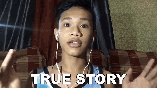 a young boy wearing ear buds is sitting on a couch and says true story