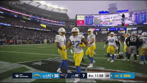 a football game is being played in a stadium sponsored by visa and gillette