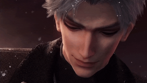 a close up of a man 's face with snow on his glove