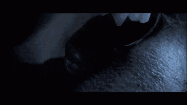 a close up of a person 's face in the dark