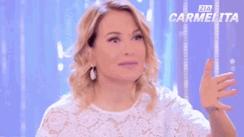 a woman in a white lace top says okay on a purple background
