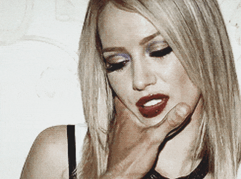 a woman with red lipstick is being held by a man