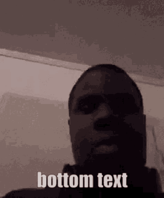 a man is looking at the camera with the words bottom text written on the bottom of his face .