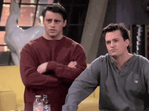 a couple of men standing next to each other with their arms crossed