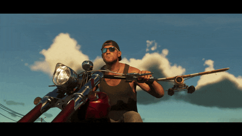 a man is riding a motorcycle while holding a skateboard