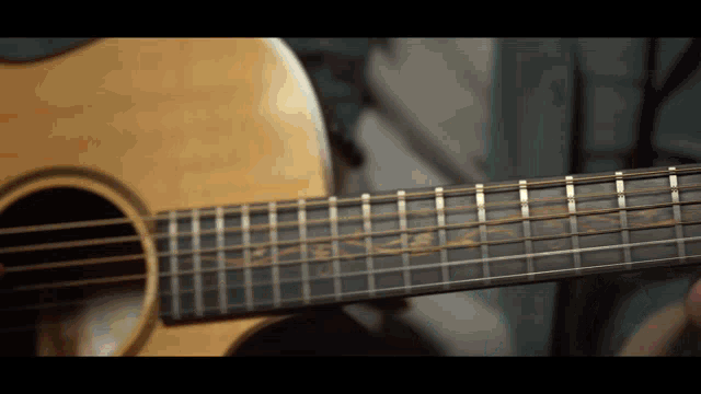 a close up of the neck of an acoustic guitar with the letters ss on it