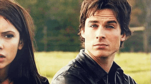 a man and a woman are looking at each other