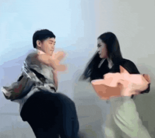a man is being lifted by a woman who is holding a pig