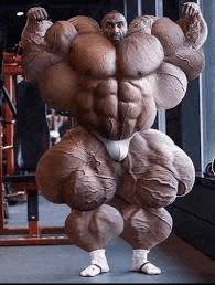 a very muscular man is standing in a gym .