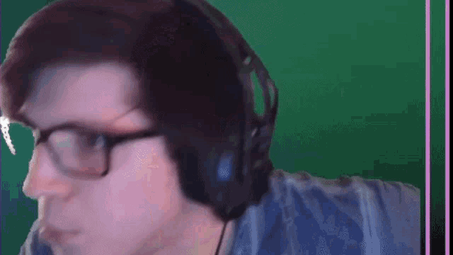 a man wearing glasses and headphones with the word what above him