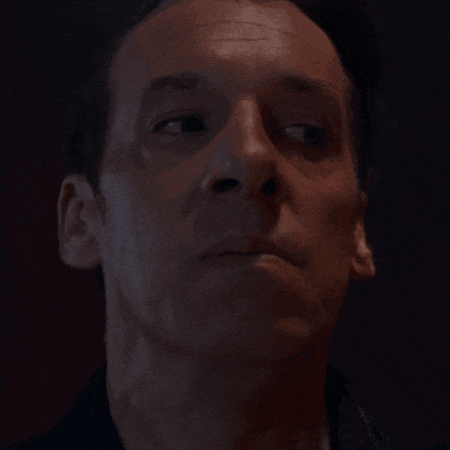 a close up of a man 's face with a red background