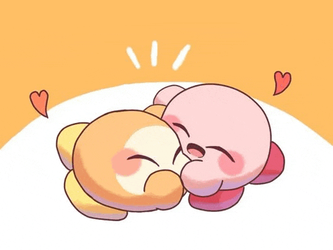 a couple of cartoon characters are laying next to each other on a table .