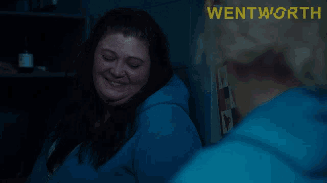 an advertisement for wentworth shows a woman in a blue sweatshirt