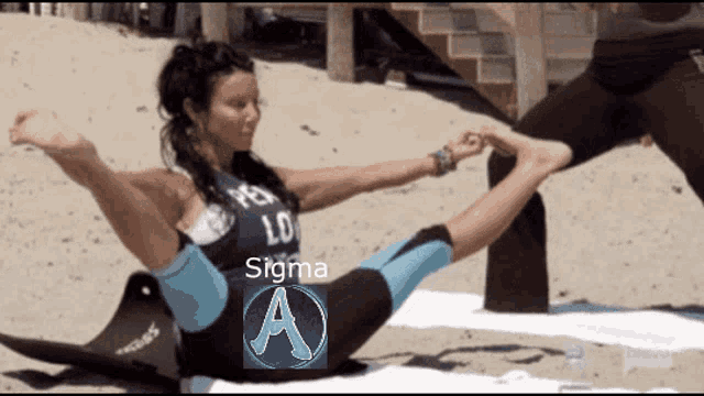 a woman is doing yoga on the beach and the word sigma is on the screen