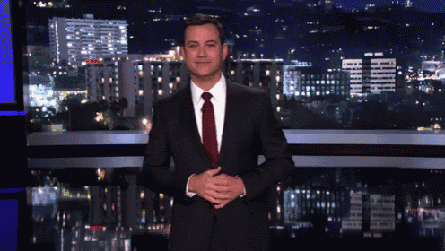 a man in a suit and tie is standing in front of a city skyline
