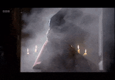 a man in a red cape is surrounded by candles and smoke with bbc written on the bottom