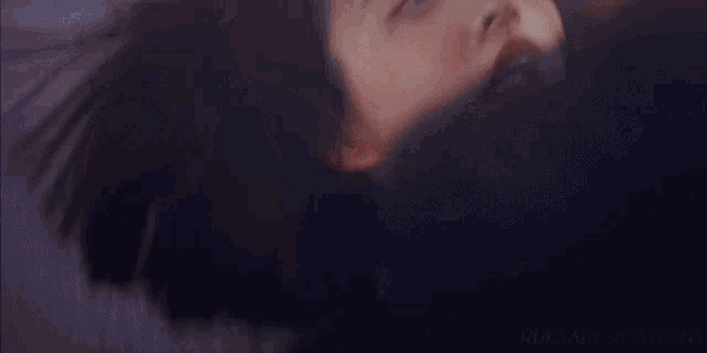 a close up of a woman 's face with a man kissing her