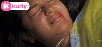 a close up of a woman 's face with blood coming out of it .