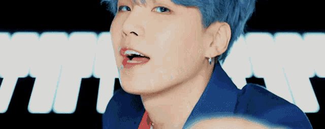 a close up of a person 's face with blue hair