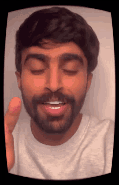 a man with a beard is making a funny face