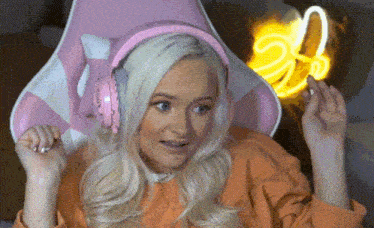 a blonde woman wearing pink headphones with the number 23 on them